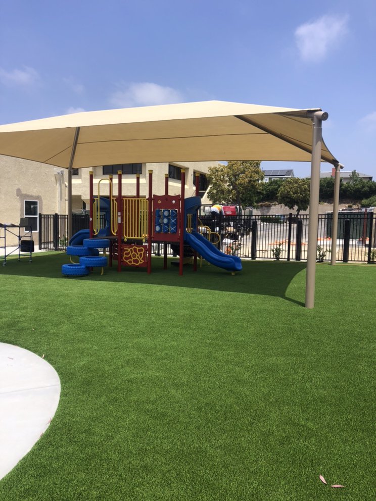 Synthetic turf playground with portable gazebo.