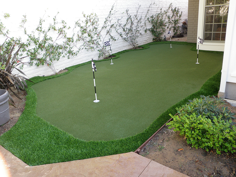 Artificial grass putting green in backyard.